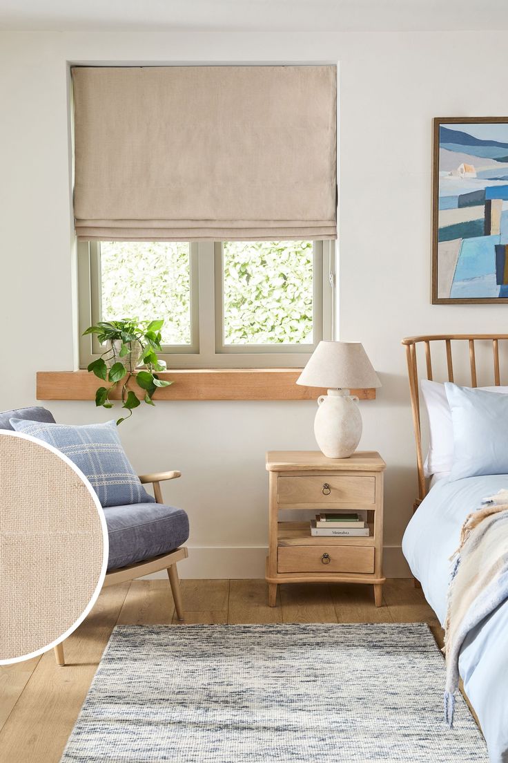 a bed room with a neatly made bed next to a night stand and a window