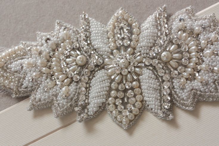 Vintage inspired beading gives a nostalgic picturesque look to every wedding attire. Each piece is carefully handcrafted using opulent swarovski stones and silk thread, making it a perfect heirloom piece. * Ivory, white and offhwite bead work* Width of the bracelet is about 2 inches approximately* The length of the beaded section is about 3.5 to 4 inches and finished with ivory tulle fabric. Shipping : Made to order, please allow 4 to 6 weeks to complete work Shop Policy : Due to the delicate, m Embellished Belts, Bracelets Embroidery, Bridal Jewelry Bracelets, Bracelet Embroidery, Winter Bridal Jewelry, Bracelets Wedding, Embroidery Wedding, Embroidery Bracelets, Bridal Accessories Jewelry