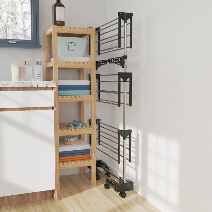 a kitchen with white walls and wooden flooring next to an open shelf on the wall