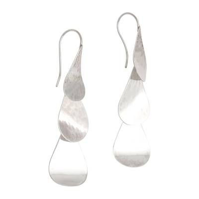 The shimmer of cascading raindrops comes to mind in these sterling silver dangle earrings from Bali's Candradewi. The droplets on top are affixed to silver ear wires while the two below dangle gracefully. The earrings feature a high-polish lightly hammered finish that adds to the allure. Contemporary Silver Drop Earrings, Contemporary Silver Drop Jewelry, Modern Silver Teardrop Linear Earrings, Silver Long Drop Linear Earrings, Modern Sterling Silver Drop Linear Earrings, Modern Silver Drop Earring Set, Nickel-free Dangle Drop Earrings, Silver Drop Chandelier Earrings, Modern Sterling Silver Teardrop Dangle Earrings