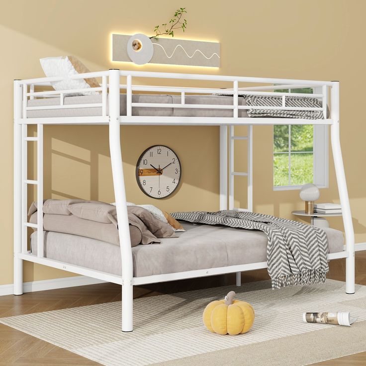 a white bunk bed sitting on top of a hard wood floor