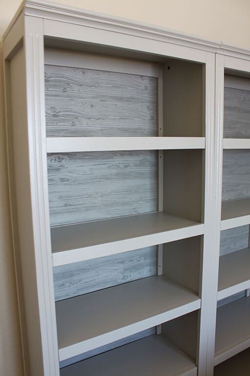 an empty white bookcase in a room