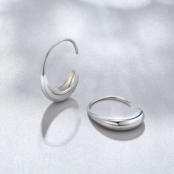 These earrings were designed to add a unique twist to the must-have gold hoop trend. Classic, timeless, and guaranteed to elevate any look. Silver plated Size: 1in x 0.8in Holds safely in the ear Lightweight Hypoallergenic, lead & nickel free If you aren't in LOVE with your purchase, please let us know within 30 days of receiving your item, and you'll receive a stress-free refund. Modern Twist Silver Hoop Jewelry, Trendy Silver Metal Wrap Earrings, Modern Silver Teardrop Huggie Earrings, Modern Nickel-free Hoop Wrap Earrings, Trendy Sterling Silver Hoop Earrings With Ear Wire, Trendy Silver Hoop Earrings For Anniversary, Modern Twist Silver Hoop Earrings With Ear Wire, Trendy Nickel-free Silver Wrap Earrings, Modern Adjustable Hoop Wrap Earrings