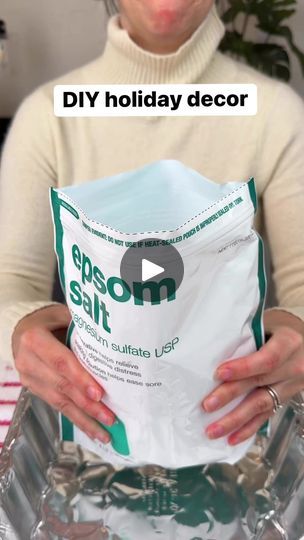 a woman holding up a bag of epson salt in front of her face with the caption diy holiday decor