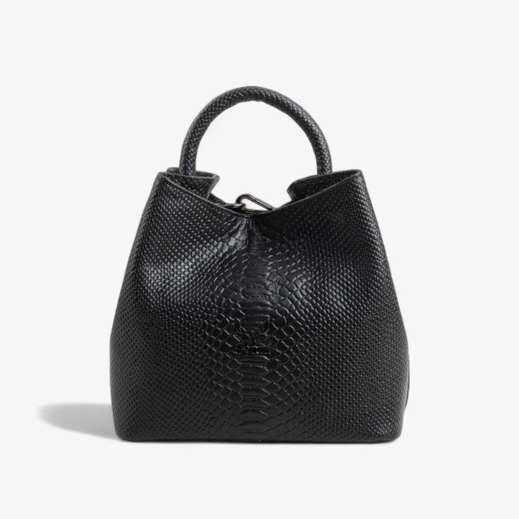 Elevate your accessory collection with our exquisite Black Leather Handbag, featuring a distinctive round handle that adds a modern touch to its classic design. Crafted from genuine leather with an elegant embossed pattern, this handbag is a testament to skilled craftsmanship, meticulously processed in our factory from start to finish. Key Features: Modern Design: The unique round handle and embossed leather pattern create a sophisticated and contemporary look. Premium Materials: Made from high- Luxury Handheld Bucket Bag For On-the-go, Formal Handheld Leather Bucket Bag, Formal Bucket Bag With Handle Drop, Luxury Bucket Bag With Top Carry Handle, Luxury Handheld Bucket Bag For Everyday, Classic Hobo Bag With Top Handle, Formal Bucket Bag With Top Carry Handle, Luxury Handheld Bucket Bag For Formal Occasions, Luxury Formal Handheld Bucket Bag