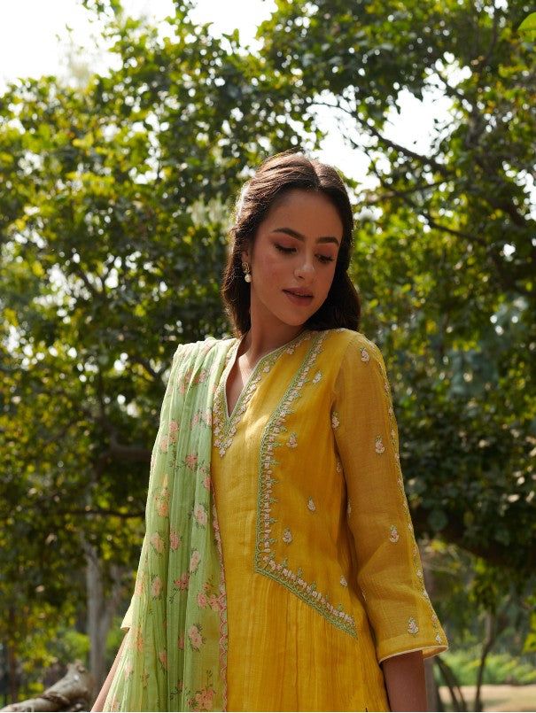 Kurta with pretty Dori embroidery, print dupatta & pants Fabric: Handwoven Mal Cotton Silk Color: Yellow Embroidery Details: Thread embroidery Note: Wash Care - Dry clean only The product will be shipped within 20-25 days of order placed Measurement: Kurta / Dress / Top Standard Body Measurement ( in Inch) Size Bust Waist Hip Shoulder Armhole Sleeve Length XS 34 32 36 14 16.5 16 46 S 36 34 38 14 17 16 46 M 38 36 40 15 17.5 16 46 L 40 38 42 15.5 18.5 16 46 XL 42 40 44 16 19.5 16 46 XXL 44 42 46 1 Print Kurti Designs Style, Yellow Mulmul Sharara With Dupatta, Yellow Mulmul Palazzo Set With Dabka Work, Yellow Palazzo Set With Dabka Work In Mulmul, Yellow Mulmul Sets With Dabka Work, Embroidered Anarkali Slub Silk Sets, Anarkali Embroidered Slub Silk Sets, Yellow Mulmul Sets With Traditional Drape, Yellow Mulmul Set With Dupatta