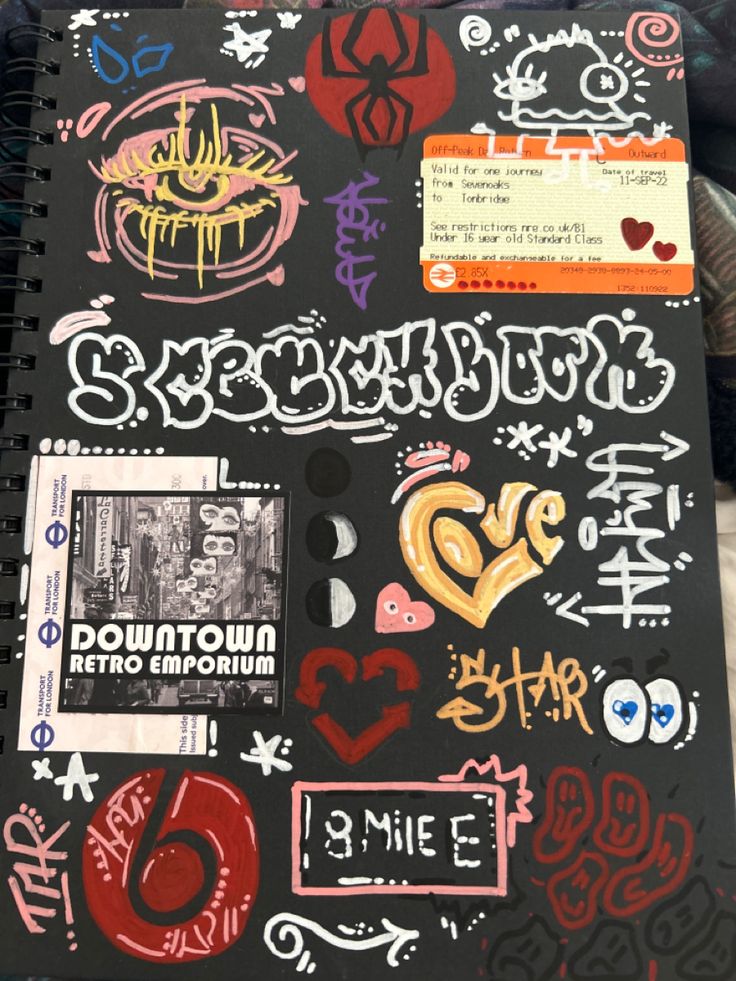 a notebook covered in stickers and writing