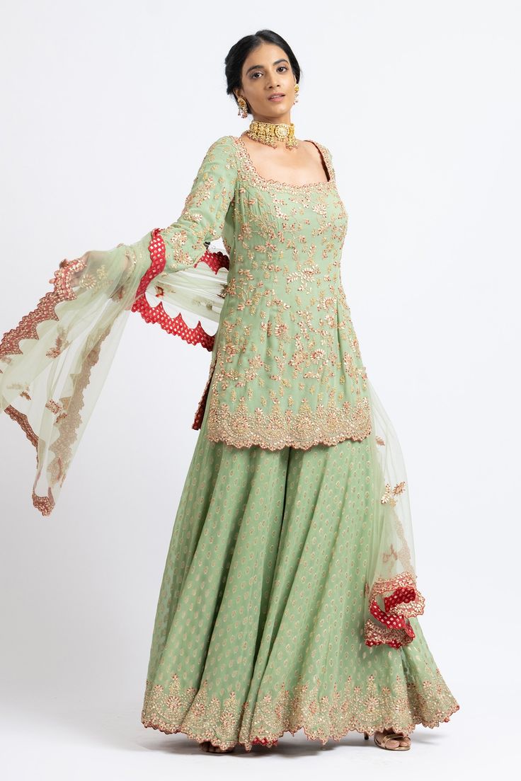 Jade green kurta with floral motifs in gota and bead embroidery. Paired with banarasi woven sharara and embroidered dupatta.
Component: 3
Pattern: Embroidered
Type Of Work: Floral
Neckline: Sweetheart
Sleeve Type: Long Sleeves
Fabric: Georgette, Net
Color: Green
Other Details: 
Tassel detail
Embroidered dupatta
Banarasi woven sharara
Occasion: Wedding - Aza Fashions Kurta Sharara Set, Kurta Sharara, Embroidered Dupatta, Sharara Set, Anarkali Dress, Sweetheart Neck, Bead Embroidery, Floral Motifs, Jade Green