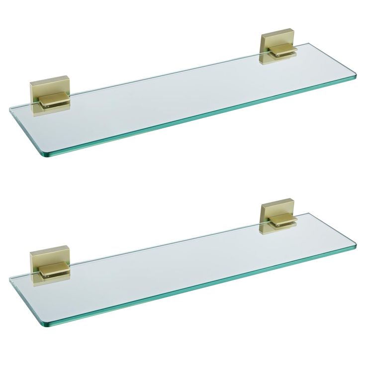 two glass shelves with gold handles on them