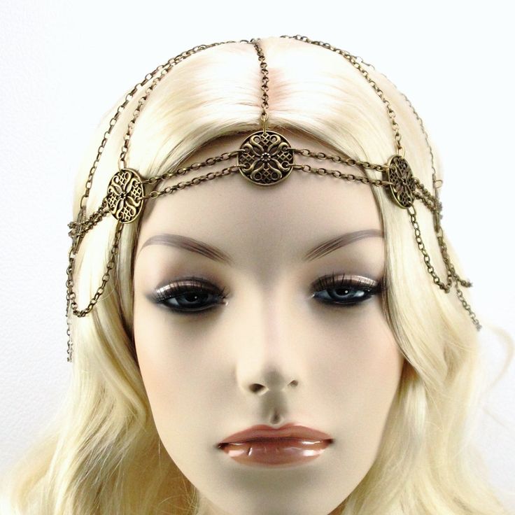 Maiden Wasila Headchain in Antique Bronze In a world that thrives on tradition and routine, the unexpected is sure to leave a lingering impression. The eye-catching Maiden Wasila headchain is an elegant and special touch to your Medieval or Renaissance era costume. This memorable Medieval headpiece features elegant floral medallions at each station along a network of fine antique bronze chain. Graceful chains drape from each station creating a flowing feminine look. See beyond a simple necklace Adjustable Metal Body Chain For Festivals, Bohemian Gold Body Chain For Festivals, Gold Bohemian Body Chain For Festivals, Gold Bohemian Body Chain, Bohemian Festival Body Jewelry With Chain, Bohemian Chain Body Jewelry For Festivals, Bohemian Gold Metal Body Chain, Bohemian Body Jewelry With Chain For Festivals, Adjustable Body Chain For Festivals