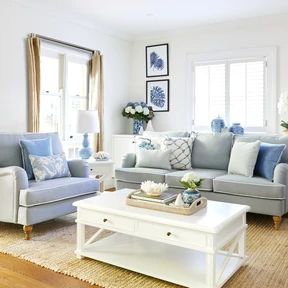 a living room with blue and white furniture