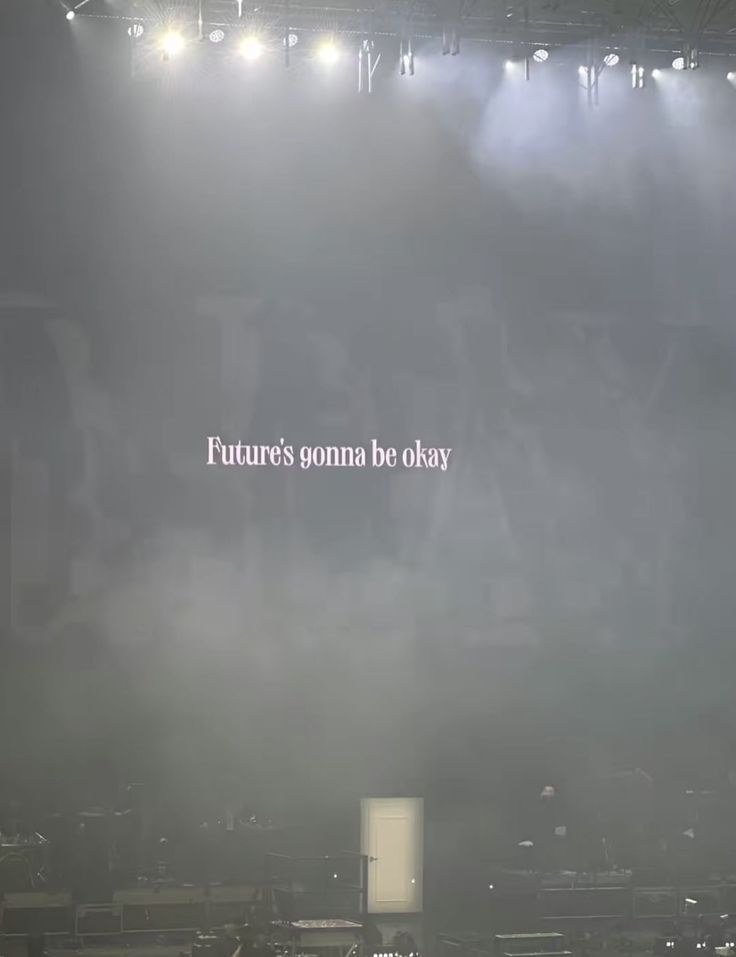 the words future's omna be okay are projected on a foggy stage