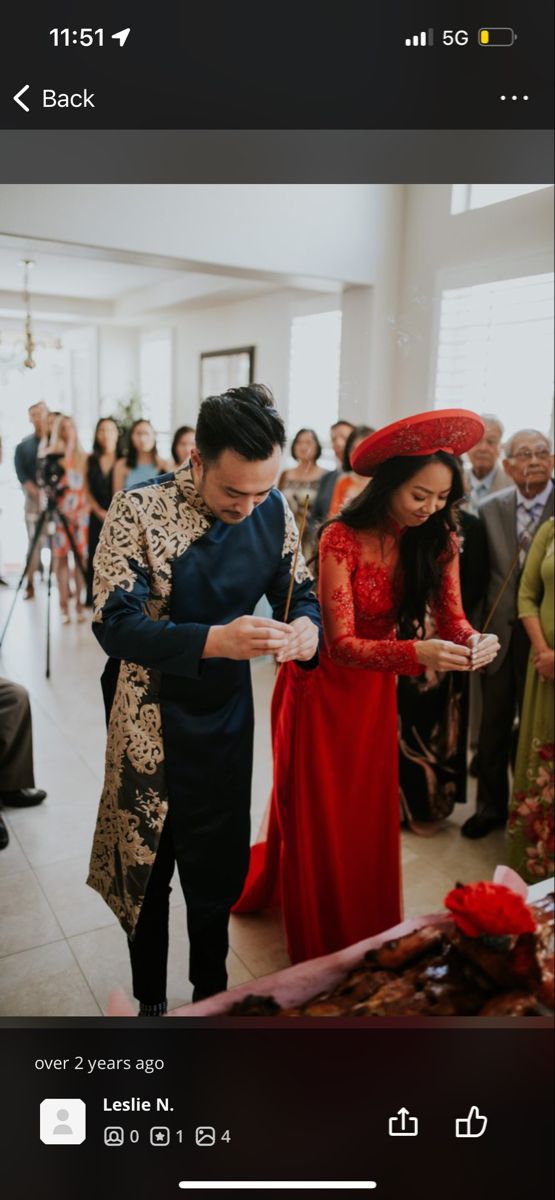 a man and woman standing next to each other in front of a table full of people