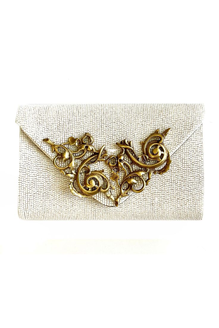 White clutch featuring baroque embellishment on a hand cast solid brass and hand embroidered beaded base.
Type: Embellished, Hand Embroidered
Composition: Solid Hand Cast Brass, Lining: Silk
Color: White
Other Details: 
Removable shoulder chain
Quilted silk lining
Measurement: L x W (in inches): 8.75 x 5.5
Closure: Flap opening
 - Aza Fashions Luxury Evening Bag With Gold Embroidery For Wedding, Gold Clutch With Gold Embroidery For Formal Occasions, Gold Hand Embellished Evening Bag, Elegant Embellished Evening Bag For Festive Occasions, Formal Gold Embroidered Evening Bag, Gold Hand Embellished Bag For Events, Luxury Embellished Clutch For Events, Elegant Hand Embellished Evening Bag For Festive Occasions, Formal Hand Embellished Gold Bags