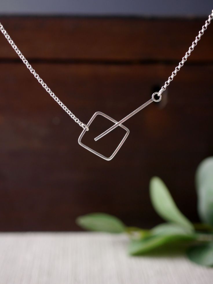 A minimal and contemporary silver pendant. Simple and stylish. A lovely geometric silver necklace. Handmade in sterling silver. Handmade in my studio in the beautiful city of Canterbury, England. Click the link to find out more..... #minimalsilverpendant #lovesquares #loveminimalism #simpleandstylish #handmadesilverpenant #everydaypendant #strikingpendant #edgypendant #funkypend...#Exploring #of #Jewelry #Embracing #Exploring #World #Elegance #the #and #Jewelry #Simplicity #Minimalist #Beauty Handmade Silver Jewelry Minimalist, Gold Jewelry Simple Earrings, Minimalist Silver Necklace, Geometric Silver Jewellery, Canterbury England, Simple Statement Necklace, Silversmithing Jewelry, Contemporary Handmade Jewelry, Modern Silver Jewelry