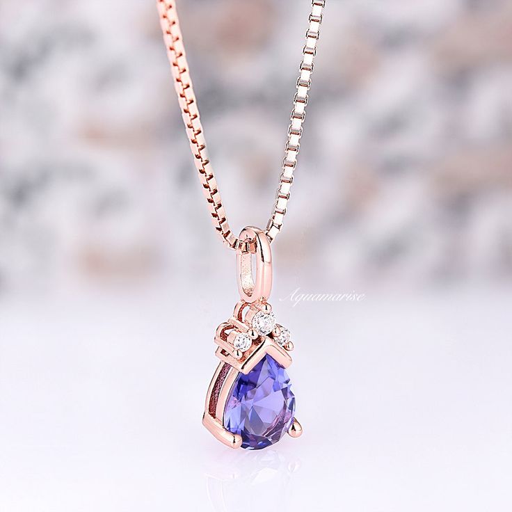 Exquisitely crafted Minimalist Teardrop Tanzanite Necklace, a stunning representation of elegance and sophistication. Meticulously designed for the contemporary woman with a penchant for timeless allure, this necklace seamlessly marries the understated charm of minimalism with the captivating allure of Tanzanite, all delicately embraced by the lustrous 14K Rose Gold Vermeil.►The pendant features a gracefully sculpted teardrop-shaped lab-created Tanzanite gemstone, renowned for its enchanting vio Elegant Teardrop Gemstone Necklaces, Elegant Gemstone Drop Necklace For Anniversary, Elegant Oval Pendant Drop Necklace For Gift, Elegant Briolette Gemstone Drop Necklace, Elegant Pear-shaped Drop Necklace Gift, Elegant Oval Pendant Gemstone Drop Necklace, Elegant Rose Gold Teardrop Pendant Necklace, Elegant Pear-shaped Birthstone Drop Necklace, Elegant Pear-shaped Rose Gold Necklace