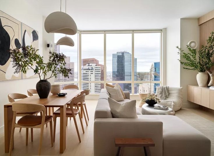 a living room filled with furniture and a large window