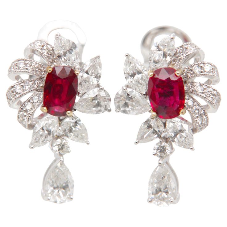 Introducing a timeless creation from Rewa Jewelry, these ruby and diamond earrings are a harmonious blend of classic inspiration and contemporary elegance—an exquisite masterpiece that showcases the brand's dedication to superior craftsmanship and enduring beauty. Inspired by classic design elements, these earrings feature a captivating pair of rubies at the center, totaling 1.60 carats. Certified by Gem Research Swisslab (GRS), these rubies boast the highly sought-after 'Pigeon Blood' Red color Luxury Ruby Earrings With Intricate Design, Elegant Ruby Earrings Gia Certified, Luxury Red Diamond Earrings, Formal Red Diamond Earrings With Brilliant Cut, Luxury Diamond Earrings With Prong Setting, Formal Red Diamond Earrings, Formal Ruby Gemstone Diamond Earrings, Luxury Ruby Earrings With Prong Setting, Ruby Gemstone Diamond Earrings For Formal Occasions