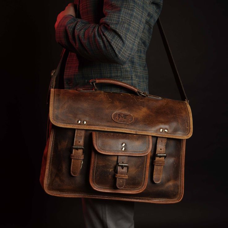 Trustpilot The man who follows the old-school style would never face formal or informal rejection. The Roosevelt buffalo leather satchel bag is designed to keep in mind a pure handmade and vintage look with excellent modern craftsmanship. This bag is wrapped perfectly with canvas and well stitched with hard Nylon thread. This bag looks like a Leather laptop satchel with a vintage look that goes rich in color with time. The bag comprises 3 major compartments including a soft padded which can hold Vintage Leather Standard Backpack, Rugged Leather Satchel Laptop Bag, Business Satchel Saddle Bag With Waxed Finish, Classic Waxed Canvas Satchel For Everyday Use, Vintage Leather Backpack-style Shoulder Bag, Vintage Leather Satchel Shaped As Standard Backpack, Business Saddle Bag With Waxed Finish And Satchel Shape, Rugged Everyday Satchel Shoulder Bag, Waxed Canvas Satchel Laptop Bag