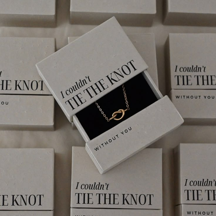 the knot necklace is in its box on top of several other cards that say, i couldn't the knot without you