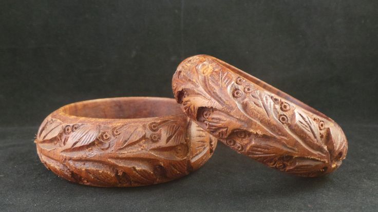 Lovely pair of vintage wood bangle bracelets. This is a matching pair, one a little wider than the other. Deeply carved design of flowers and leafy stems. Very ethnic design. Bracelets measure 1 1/8 inches and 1 inch wide respectively. They fit a small wrist, only 2.5 inches across. Too big for my large hand. Very light wear and natural variations in the wood color. Shop Policies: Shipping: All items will be shipped through the USPS unless otherwise marked. Most items will be shipped first class Traditional Handmade Brown Bangle, Brown Carved Bangle Bracelets, Brown Carved Bracelet Jewelry, Vintage Carved Brown Bracelets, Vintage Brown Carved Bracelets, Carved Brown Bangle Jewelry, Brown Carved Bangle Jewelry, Bohemian Carved Bangle Bracelet, Vegan Jewelry