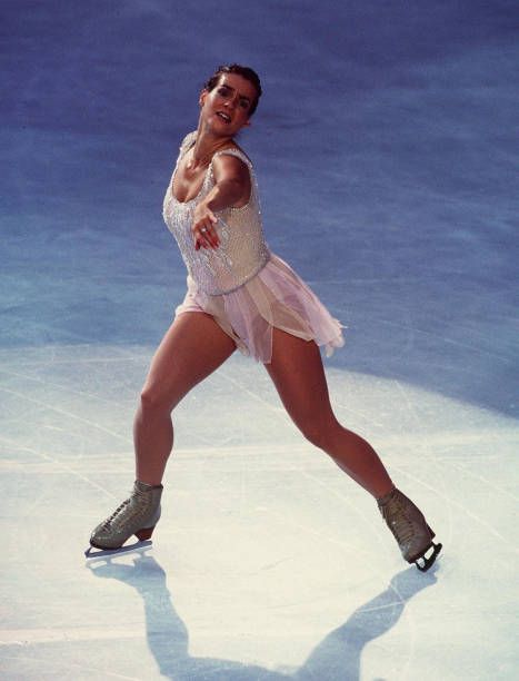 a female figure skating on an ice rink