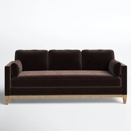 a brown couch sitting on top of a white floor