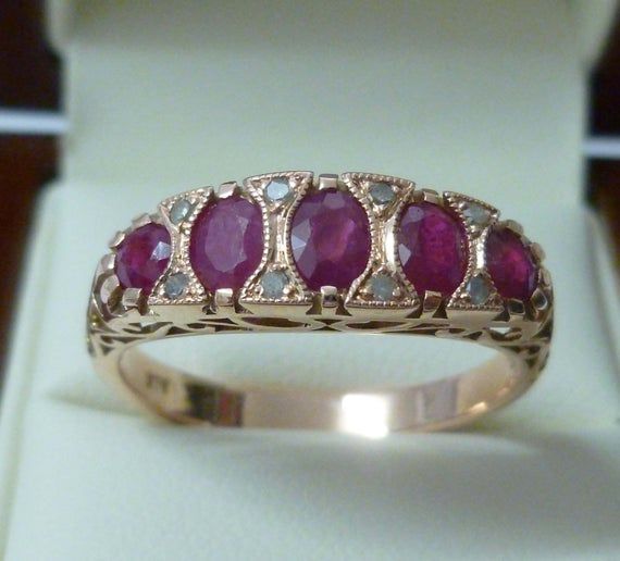 This BEAUTIFUL Vintage Inspired ring has been crafted from 9ct Solid Rose Gold. The pierced gallery has ornate scroll designs and the face has Oval Cut NATURAL Rubies which have been prong set. The outer Ruby gemstones are round cut. GENUINE earth mined round diamonds have been prong set in triangular patterns completing this gorgeous ring THIS VINTAGE INSPIRED RUBY & DIAMOND RING IS TRULY AN EXQUISITE FINE JEWELLERY PIECE WHICH IS TO BE TREASURED FOR A LIFETIME ! • FREE GIFT BOX PROVIDED• A Vintage Ruby Ring, Antique Ruby Ring, Antique Emerald Ring, Gold Ruby Ring, Ruby Ring Vintage, Ruby Jewellery, Antique Rings Vintage, Womens Rings, Ruby Ring Gold