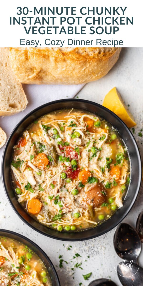 two bowls of chicken vegetable soup with bread on the side