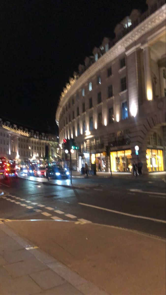 a busy city street at night with traffic