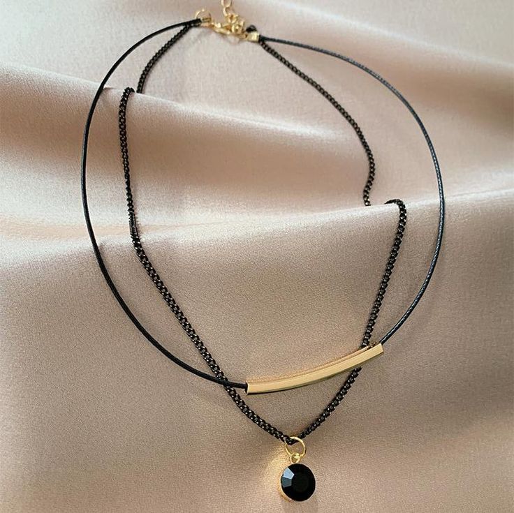 ✦ Indulge in the sophistication and exclusivity of this stunning two-layer necklace. Elevate any outfit and exude effortless style with this elegant, yet seductive piece. Expertly crafted with premium materials and a delicate design, it is a must-have for any fashion-forward individual. Be the subject of envy among your peers with this sleek black necklace. The perfect present for a loved one, be it your significant other, mother, sister, or daughter. ----------- DETAILS ----------- Color: Black Size (Length): 33.5cm (inner); 36.5cm (outer) Extension Chain Length: 7cm Materials: 316L Surgical Steel, 18K Gold Plated, Cubic Zirconia, Faux Leather *316L Stainless Steel is hypoallergenic, generally safe for sensitive skin. - SKU: HN518 Elegant Metal Layered Necklace For Party, Elegant Double Strand Metal Layered Necklace, Elegant Adjustable Double Chain Necklaces, Elegant Layered Necklace With Adjustable Double Chain, Elegant Metal Jewelry With Double Chain, Adjustable Double Strand Layered Necklace For Party, Elegant Metal Double Chain Jewelry, Layered Minimalist Metal Jewelry, Minimalist Metal Layered Necklace For Party