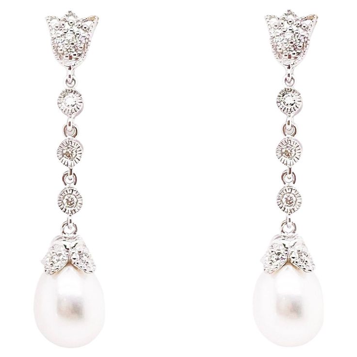 These stunning pearl earrings are the perfect wedding day look or for a formal outfit! The simple elegance of the diamonds and drop pearl scream the perfect wedding day accessory or dressy look! The details for these gorgeous earrings are listed below: 1 Set Metal Quality: 14K White Gold Earring Type: Drop Diamond Number: 10 Diamond Shape: Round Brilliant Diamond Total Weight: .14 ct Diamond Clarity: VS2 (excellent, eye clean) Diamond Color: G (excellent, near colorless) Diamond Shape: Round Brilliant Gemstone: Freshwater Pearl Gemstone Color: White w High Luster Gemstone Weight: 1.29 ct Measurements: 7 - 7.5 millimeters Post Type: Stud Total Carat Weight: 1.43 ct Wedding Dangle Earrings, Wedding Pearl Earrings, Vintage Diamond Earrings, Floral Design Wedding, Formal Earrings, Dangle Earrings Wedding, Pearl Earrings Wedding, Pearl And Diamond Earrings, Colorless Diamond