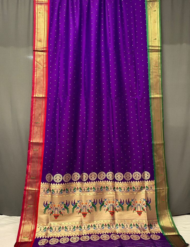 Package Contains: Saree, Blouse, Petticoat Ganga Jamuna border in combination with Paithani weaving Silk Sarees with elegant rich Pallu and allover buttes. With FREE Saree fall and Pico with matching petticoat. Our Services- Stitching service is also available on customer demand. Please get in touch with us for Stitching Service. We customize everything when it comes to ethnic wear. We also make plus size in ethnic wear. So, feel free to contact us. Before dispatch, we check our product to serve you, our best. Beware of fake sellers. We are giving assured quality. So, you will always receive an excellent product. Festival Paithani Silk Choli With Traditional Patterns, Navratri Blouse Piece With Border For Traditional Ceremonies, Eid Purple Blouse Piece With Embroidered Border, Navratri Traditional Chanderi Wear With Border, Festive Puja Blouse Piece With Border, Traditional Purple Kurta With Pallu, Navratri Chanderi Traditional Wear With Border, Anarkali With Border For Puja, Navratri Anarkali Traditional Wear With Border