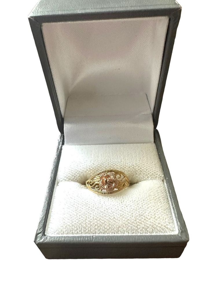 This beautifully designed Michael Anthony ring features a yellow gold band with an ornate design on the front topped with a rose gold rose in the middle. The face of the ring measures to be about 1.5 centimeters wide. Although the ring holds no marks or tarnishing, there is slight scuffing on the back of the band. This can easily be polished to restoration. Please note, the ring's band is slightly bent due to storage (pictured). Again, this can be easily resolved by taking it into a jeweler. American Jewelry designer, Michael Anthony, founded his company in 1977 in New York city. He was America's largest gold and silver jewelry producer until his company was bought out in the late 1990s.  -Procured in Malta, Europe. -Originated in the USA. -Size 3 US. -Face measures to be 1.5 centimeters w Gold Diamond Jewelry With Rose Design, Heirloom 14k Rose Gold Diamond Ring In Gold Color, Rose Gold Diamond Ring With Rose Design, Oval Rose Gold Diamond Ring Stamped 14k, Rose Gold Oval Diamond Ring Stamped 14k, Gold 14k Rose Gold Diamond Ring With Center Stone, Rose Gold Filigree Promise Ring, Gold Flower Ring With Rose Design, Gold Rose Design Flower Ring