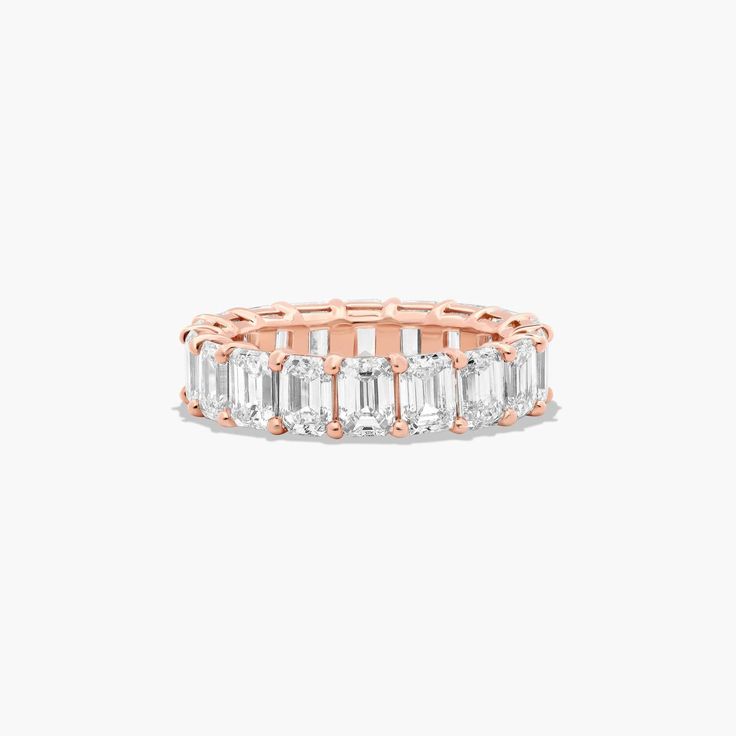 14K Rose Gold Emerald Cut Diamond Eternity Ring (6 CTW H-I / SI1-SI2). This timeless eternity ring features the boldness and elegant gleam of emerald cut diamonds. A classic, tailored shared prongs setting allows the maximum amount of the diamonds surface to show. Number of diamonds and carat total weight will vary depending on ring size. Yellow Sapphire Rings, Diamond Eternity Ring, Rings Mens Wedding Bands, Carved Ring, Classic Wedding Rings, Platinum Wedding Rings, Pink Sapphire Ring, Round Cut Engagement Rings, Emerald Cut Diamond