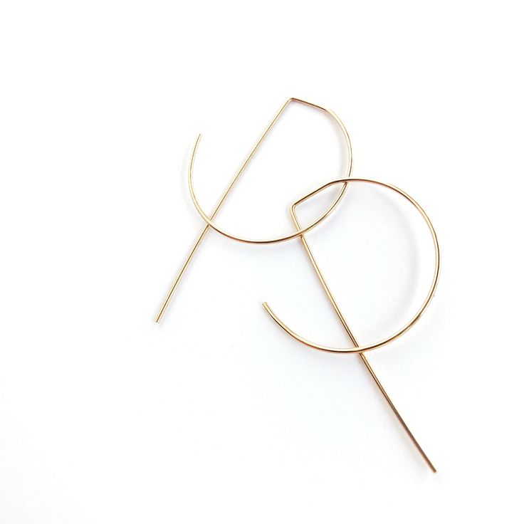 "Thank you for visiting my shop! This threader earring set is part of my \"Simplicity\" line.  Add this modernized hoop to your everyday look. Let this minimalist set be a reminder that less is really more.  All pieces are designed, cut, and shaped with care by me, Renee - right in the heart of beautiful Benicia, CA. Because of the nature of handmade pieces, slight variations occur in size, shape, and texture, however great attention is given to make each piece perfect in its own right. -------------------------------- MATERIAL: - 14K gold-filled wire - wire 20 gauge Nimble Necessity is committed to creating affordable jewelry from quality materials. 14K Gold-fill is used over gold plate. Gold-fill is an actual sheet of gold wrapped around a core metal such as brass or copper and will not Minimalist Yellow Gold Hoop Earrings, Minimalist Yellow Gold Hoop Wrap Earrings, Minimalist Gold Hoop Threader Earrings, Minimalist 14k Gold Filled Threader Earrings, Minimalist Hoop Threader Earrings, Modern 14k Gold Filled Threader Earrings, Modern 14k Gold-filled Gold Threader Earrings, Minimalist 14k Gold Filled Hoop Earrings, Minimalist Small Hoop Threader Earrings