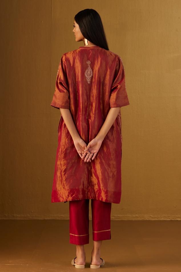 Red kaftan in Mughal brocade with floral patterns and minimal zardozi embroidery. Comes with red cotton silk pant.
Components: 2
Type Of Work: Floral
Neckline: V Neck
Sleeve Type: Three Quarter
Fabric: Kurta: Brocade and Handloom tissue, Pant: Cotton Silk, Lining: Shantoon
Color: Red
Other Details: 
Lace trims
2 pockets on kaftan and pant
Partially elasticated waistband
Length:
Kaftan: 41 inches
Pant: 36 inches
Model height: 5ft 9inches, wearing size M
Note: Dupatta worn by the model is not for Brocade Kaftan, Red Kaftan, Red Kurta, Silk Pant, Zardozi Embroidery, Lace Trims, Silk Pants, Pant Set, Floral Patterns