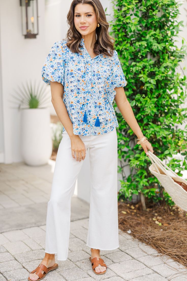 We think you are definitely going to remember this blouse very well! That ditsy floral print and those colors are all so pretty together! This bubble sleeve blouse is perfect for taking you from work to weekends! V-neckline with tassel ties Short bubble sleeves Ditsy floral print No stretch Savannah is wearing the small. Casual V-neck Blouse With Tassels, Spring V-neck Blouse With Tassel Ties, Blue Cotton Blouse With Tassels, Blue Spring Top With Tassel Ties, Blue Spring Tops With Tassel Ties, Blue V-neck Top With Tassels, Blue V-neck Tops With Tassels, Spring Blouse With Tassel Ties And Short Sleeves, Casual Short Sleeve Tops With Tassel Ties