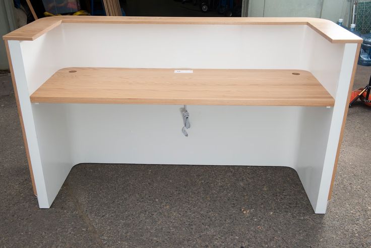 a wooden bench sitting on top of a white counter