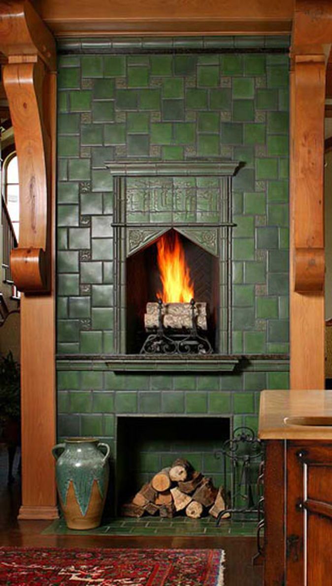 a fireplace in a living room with green tile