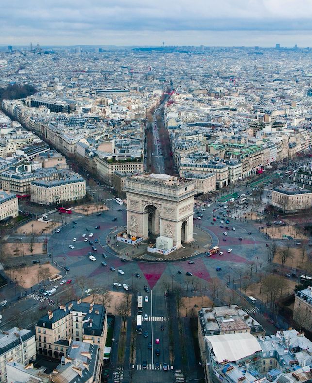 an aerial view of the eiffel tower in paris, with cars driving around it