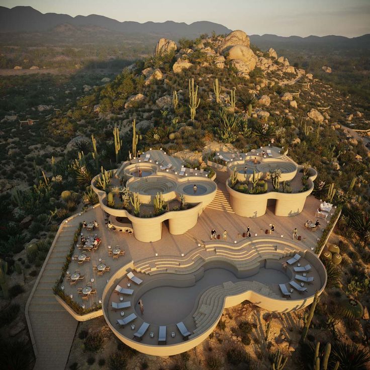 an aerial view of a resort in the desert with pools and hot tubs surrounded by cacti