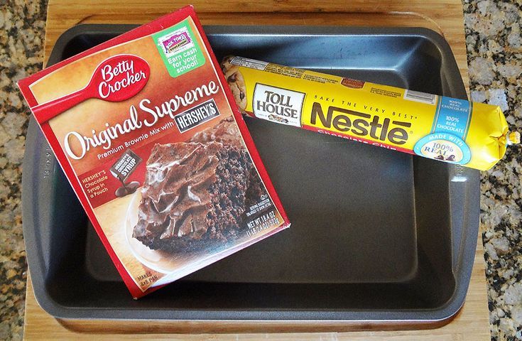 two boxes of nestle and chocolate cake sitting on a black tray next to each other