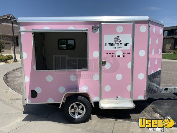 a pink trailer with white polka dots on it