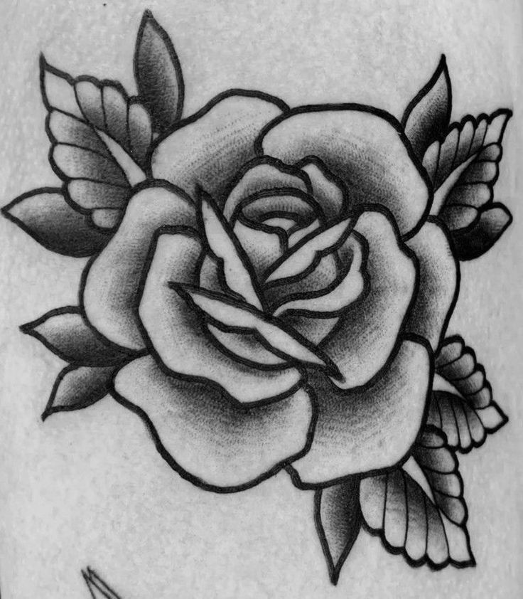 a black and white photo of a rose tattoo