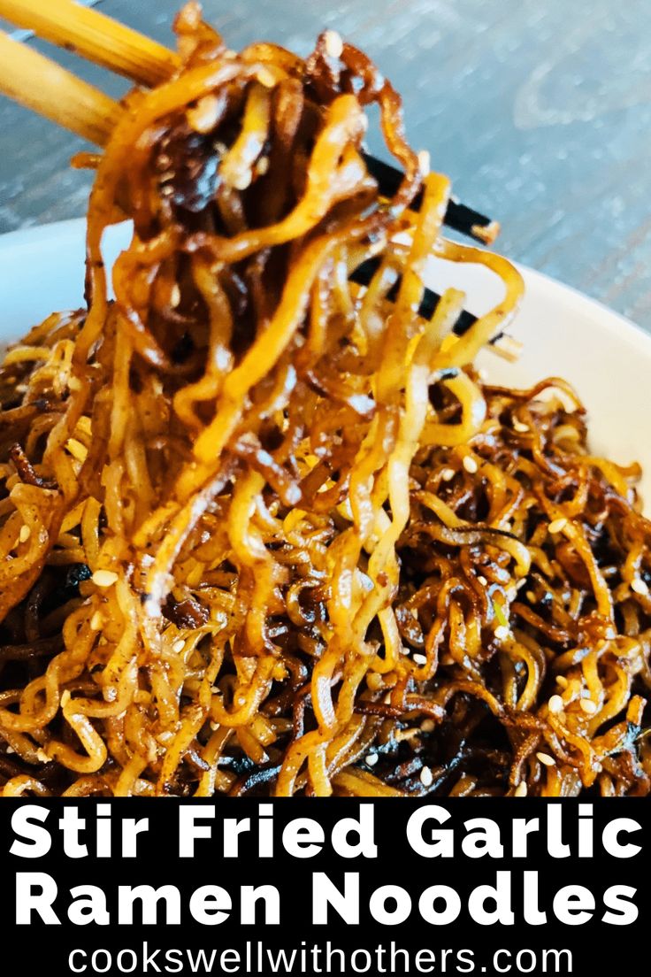 stir fried garlic ramen noodles on a white plate with chopsticks in it