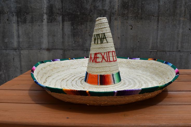 Complete your look this season with the Handmade 27 inch Jumbo Natural Palm "Viva Mexico" Sombrero. Authentically made in Mexico with natural straw. This fun hat features a colorful serape on the brim and the base of the crown and "Viva Mexico" on the front. This sombrero measures approximately 27 inches in diameter, 15 inches tall with a brim of about 11 inches wide. The interior of the hat measures approximately 57cm - 58 cm. Great for Men, Women, and Teens! Perfect for Traditional Celebrations, Parades, Festivals, Cookouts and more!  For Ages 14 and Older. *Serape colors could differ from image. Serape colors are all different* ⭐Handmade 27 inch Jumbo Natural Palm "Viva Mexico" Sombrero. Great for Men, Women, and Teens! ⭐This fun hat features a colorful serape on the brim and the base o Traditional Hat For Cinco De Mayo Festival, Traditional Hat For Beach And Cinco De Mayo, Wide Brim Straw Hat For Cinco De Mayo Festival, Traditional Curved Brim Hat For Cinco De Mayo, Traditional Wide Brim Hat For Cinco De Mayo, Multicolor Wide Brim Hat For Cinco De Mayo, Fun Hat, Festival Costume, Festival Costumes