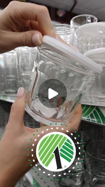 two hands holding plastic cups in front of each other