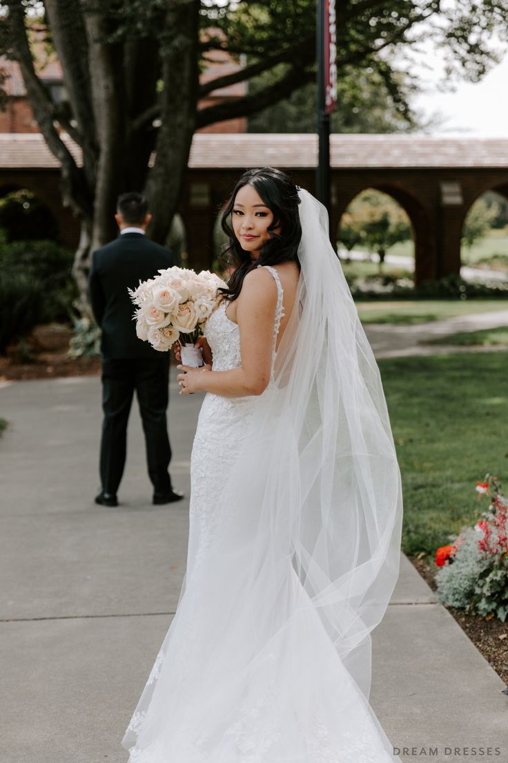 a woman in a wedding dress holding a bouquet