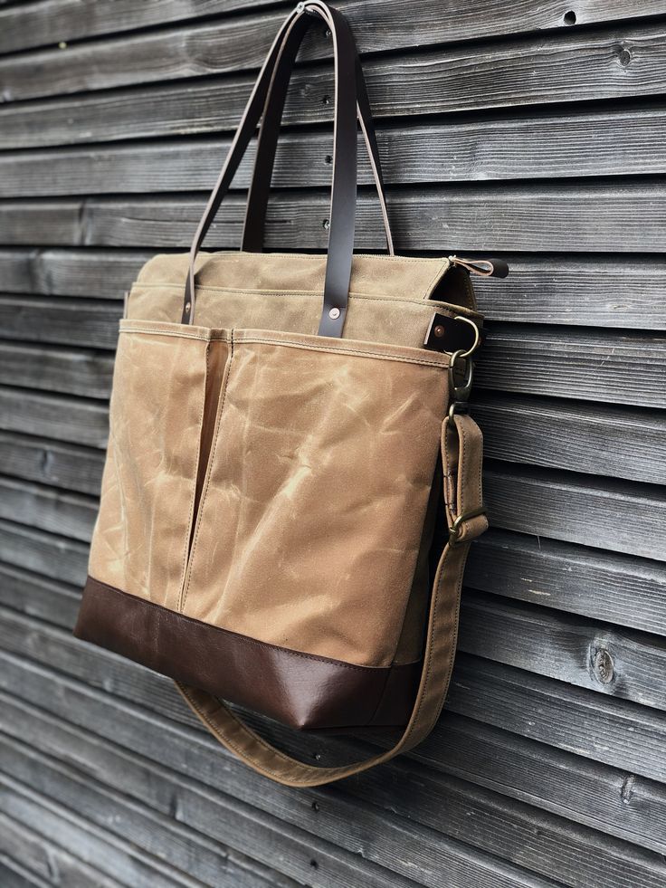 The material I used to make this bag is an American heavy weight waxed canvas. The color is spice for the body, and outside pocket on one side. The large double outside pocket is made in brush brown medium waxed canvas on the other side. I made it into an everyday bag, ideal to use as a diaper bag, because of the many pockets with oiled leather handles and bottom. Closing with a zipper. You can carry this bag in your hand, on your shoulder, or cross body with the adjustable and detachable should Canvas Tote Shoulder Bag With Silt Pocket, Everyday Brown Duck Canvas Shoulder Bag, Outdoor Waxed Finish Tote Shoulder Bag, Large Capacity Waxed Canvas Tote Shoulder Bag, Waxed Cotton Satchel Shoulder Bag, Waxed Canvas Shoulder Bag With Double Handle, Beige Waxed Canvas Tote Bag, Brown Waxed Canvas Shoulder Bag With Pockets, Daily Use Waxed Canvas Satchel With Pockets